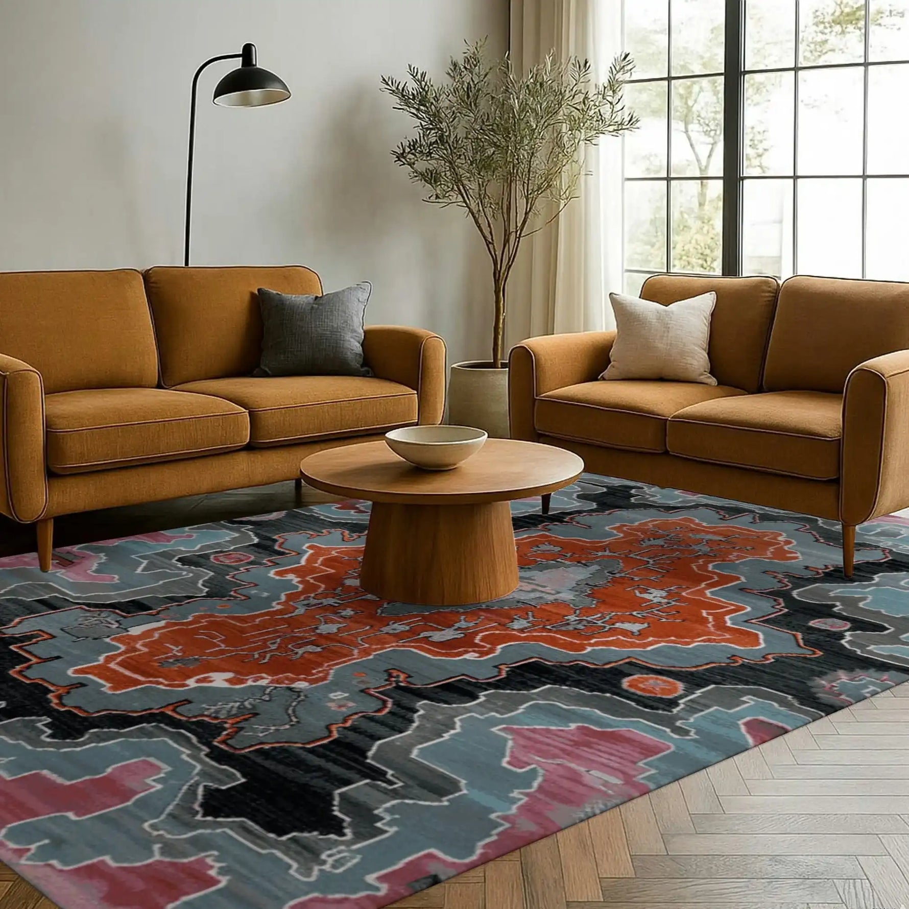 A contemporary area rug with a bold abstract design in shades of orange, blue, and black, placed in a stylish living room. The rug complements the mid-century modern decor featuring mustard-colored sofas, a wooden coffee table, and a large window that brings in natural light, perfect for enhancing any living room area.