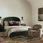 Elegant bedroom featuring a large, vintage wool area rug with intricate Persian patterns, complementing the sophisticated decor. The square rug, perfect for living rooms or offices, adds a touch of timeless elegance beneath a plush, modern bed and textured armchair.