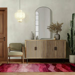 Stylish Ethereal Waves Hand Tufted Wool Runner Rug with vibrant shades of red and pink, adding a contemporary touch to the hallway. Perfect as a hallway runner rug, this area rug complements the modern decor with a wooden sideboard, a cozy chair, and a hanging light fixture. Ideal for those seeking kitchen runner rugs or living room rugs 8x10, this wool rug enhances any space with its elegant design.