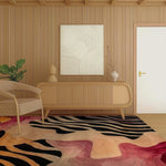 A stylish living room featuring the Evolving Forms Hand Tufted Viscose Area Rug. This large wool rug, measuring 8x10, showcases an abstract design with black, pink, and orange patterns. The rug adds a touch of elegance and warmth to the room, complementing the wooden furniture and decor.