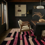 Modern dining room featuring the Evolving Shapes Hand Tufted Area Rug with abstract patterns in pink and black hues, adding sophistication to a cozy setting. Ideal for living room and dining room rugs, this wool rug enhances the formal dining room decor.