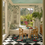 A beautifully designed living room area featuring a Festive Whimsy Round Hand Tufted Rug. This elegant area rug adds a touch of charm with its intricate patterns and vibrant colors. The wool rug perfectly complements the modern decor, making it an ideal choice for rugs for living room. The round rug is placed under a cozy dining setup, enhancing the space with its unique design.