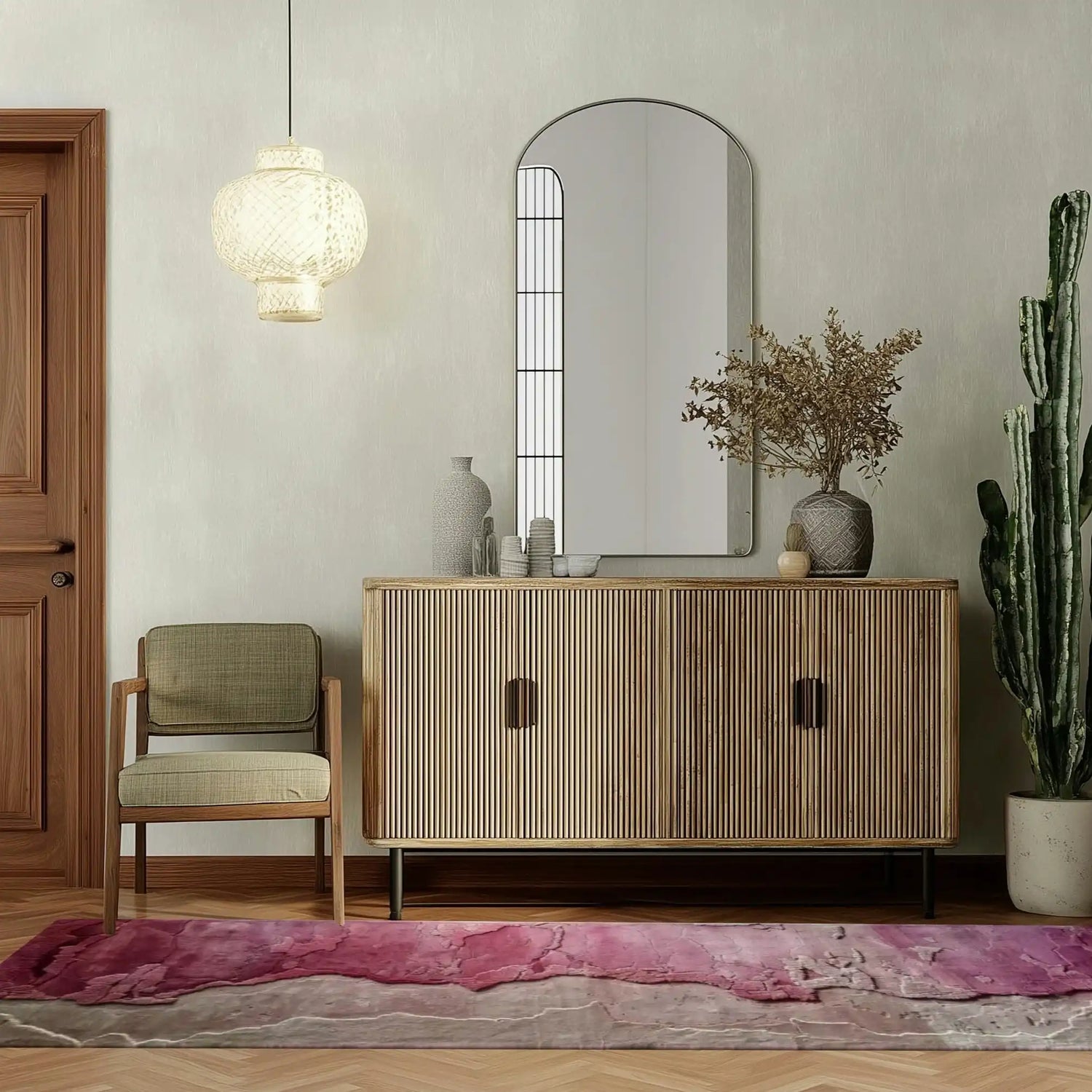 A contemporary wool runner rug with vibrant pink and neutral tones lies elegantly on a wooden floor. Its abstract design adds a modern touch, perfect for spaces like offices, kitchens, or hallways. The stylish setting includes a wooden cabinet, a chic chair, and a decorative mirror, enhancing the area rug's appeal.