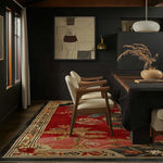Stylish living room featuring a Flame Blossom Hand Tufted Wool Rug as a large area rug. The vibrant red and floral design complements the elegant wooden chairs and dark walls, creating a cozy atmosphere. Perfect for those seeking rugs for living room or large area rugs for living room.