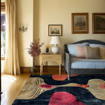 The Floral Drift Hand Tufted Rug is a striking area rug placed in a cozy living room setting. This square rug features contemporary abstract patterns with vibrant colors, perfect for adding a touch of elegance to any living room or office space. Ideal for those seeking an 8x10 wool rug, it's a beautiful addition to your area rugs for living room collection.