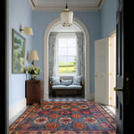 A beautifully designed floral fusion hand tufted area rug in a light-filled hallway, showcasing vibrant floral patterns. Ideal as a square area rug for offices or large living rooms, this vintage wool rug adds a touch of elegance and color to any space.