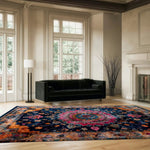 Elegant living room featuring a Floral Harmony Heritage Hand Tufted Area Rug. The vibrant floral design in rich colors beautifully enhances the space, making it ideal for both living rooms and formal dining rooms. The wool rug adds a touch of boho charm, perfectly complementing the luxurious decor and large windows.