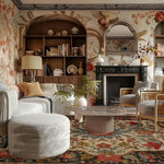 Luxurious living room with floral rug, wallpaper, bookshelves, and a fireplace.