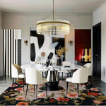 A beautifully styled living room featuring a Garden Bouquet Hand Tufted Wool Rug. This large area rug showcases vibrant floral designs, adding elegance to the room. The square area rug complements the modern decor with a chic dining table and chairs, perfect for a stylish living space. Ideal for those seeking floral rugs and wool rugs in an 8x10 size.