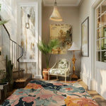 A beautifully styled living room featuring an exquisite Garden Whimsy Hand Tufted Area Rug. This wool rug showcases a vibrant floral pattern, perfect as an area rug for living rooms. The 8x10 rug adds a touch of elegance and color, complementing the chic decor with a cozy chair and indoor plants.
