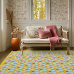 A cozy living room featuring a Gold Border Scallop and Lotus Hand Tufted area rug. The vibrant wool rug, ideal for living rooms, showcases a beautiful pattern of scallops and lotus flowers in pink and gold hues. It's a perfect 8x10 centerpiece for adding warmth and style to your space.