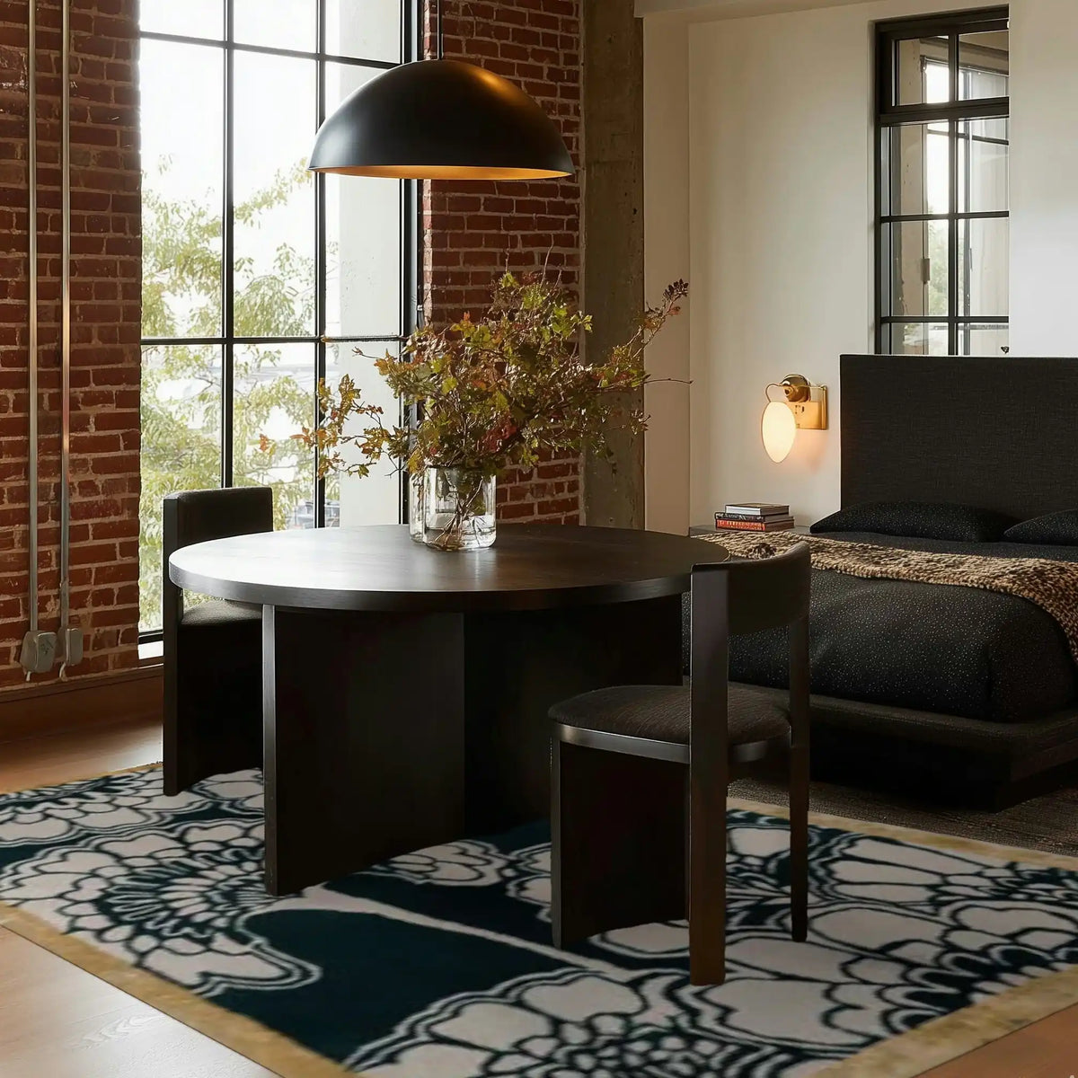 Contemporary bedroom featuring a stylish area rug with a bold floral design, perfect for adding elegance to an office or bedroom. The hand-tufted wool rug complements the modern décor, including a round table and dark chairs, creating a cozy and sophisticated environment.