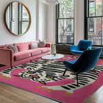 A stylish living room featuring a Hand Tufted Pink Tiger Wool Area Rug. This large area rug showcases a striking abstract tiger design, perfect for adding a vintage touch to any office or living room. The wool rug complements the pink sofa and modern chairs, creating a cozy and inviting space.