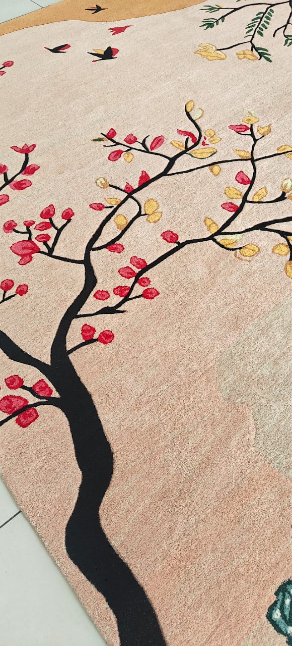 Decorative rug with a tree design featuring red and yellow leaves on a beige background.