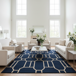Modern living room with a blue patterned rug, white furniture, and large windows.