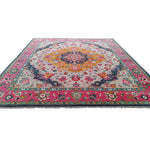 Multicolored hand tufted wool rug with intricate floral medallion design and pink border