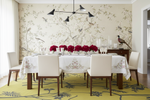 Dining room with floral rug, table set for dinner, and decorative elements.