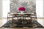 Dining room with a round table and chairs, featuring a brown art deco rug, floral arrangement on the table.