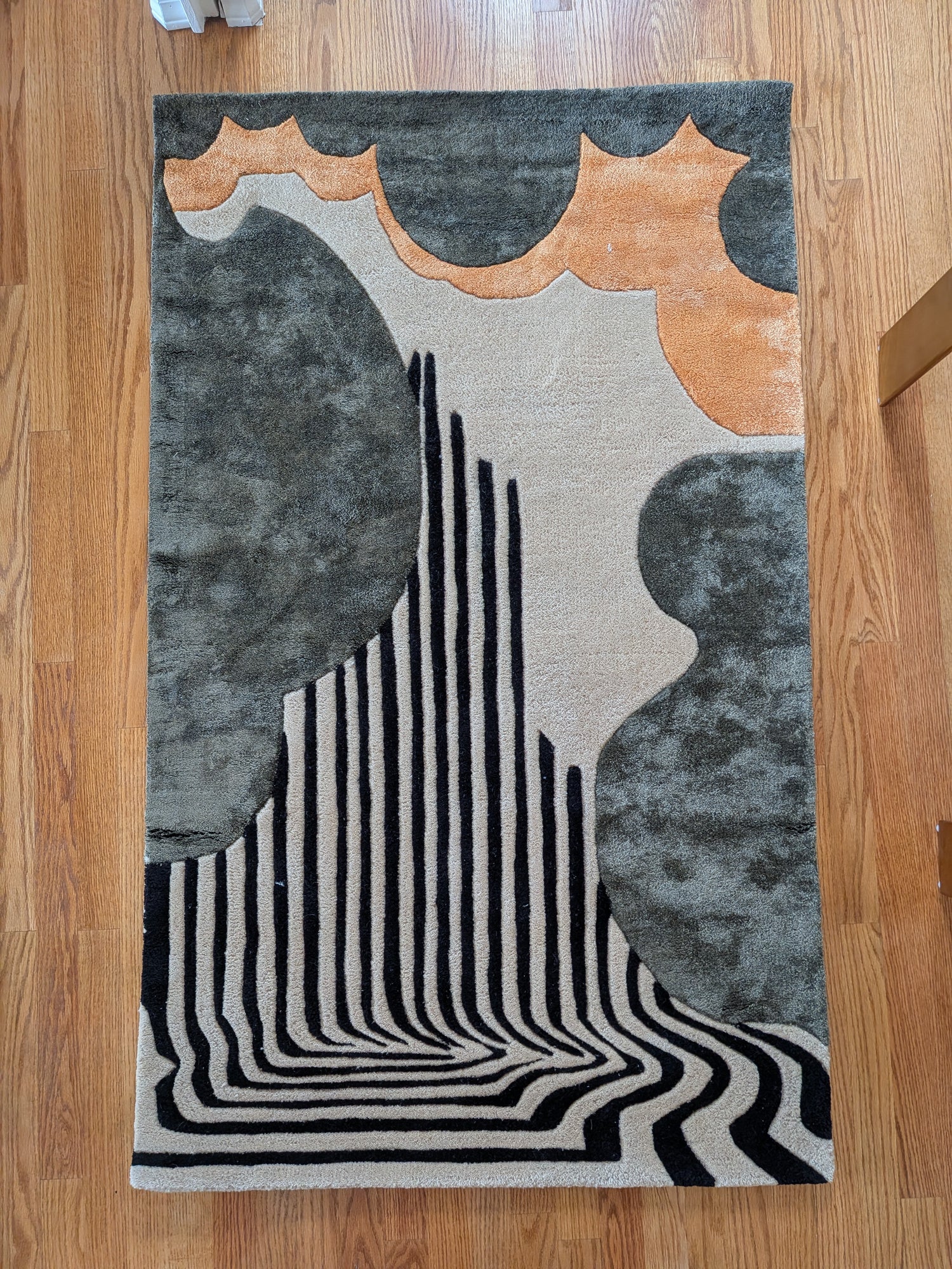 Abstract area rug with geometric design on a wooden floor