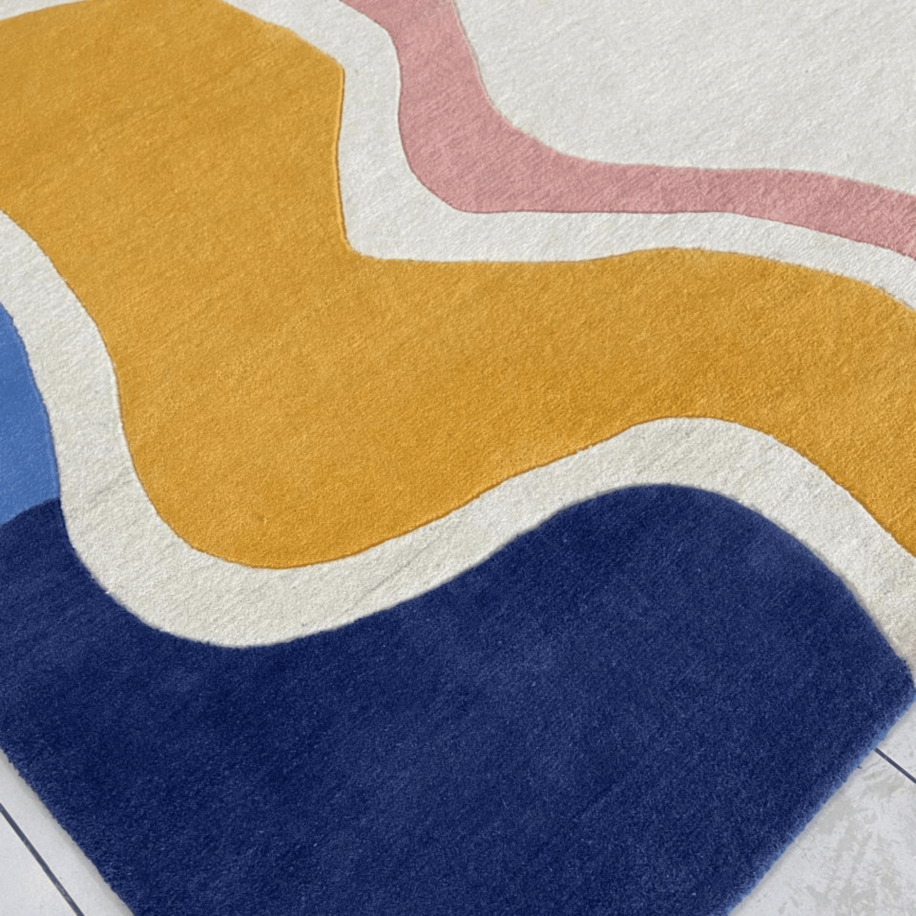 Close-up of a colorful abstract rug with wavy patterns on a light background
