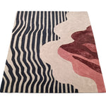 Modern abstract rug with wavy black stripe pattern and layered red and beige design elements