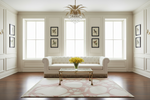 Living room with a white sofa, abstract rug, coffee table, and decorative elements.