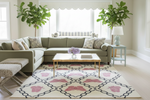 Living room with a sectional sofa, coffee table, and decorative rug.