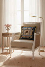 A brown leather wingback armchair with an attached ottoman, styled in a cozy room corner with a decorative blue and gold throw pillow, a brass floor lamp, and a side table with white roses.