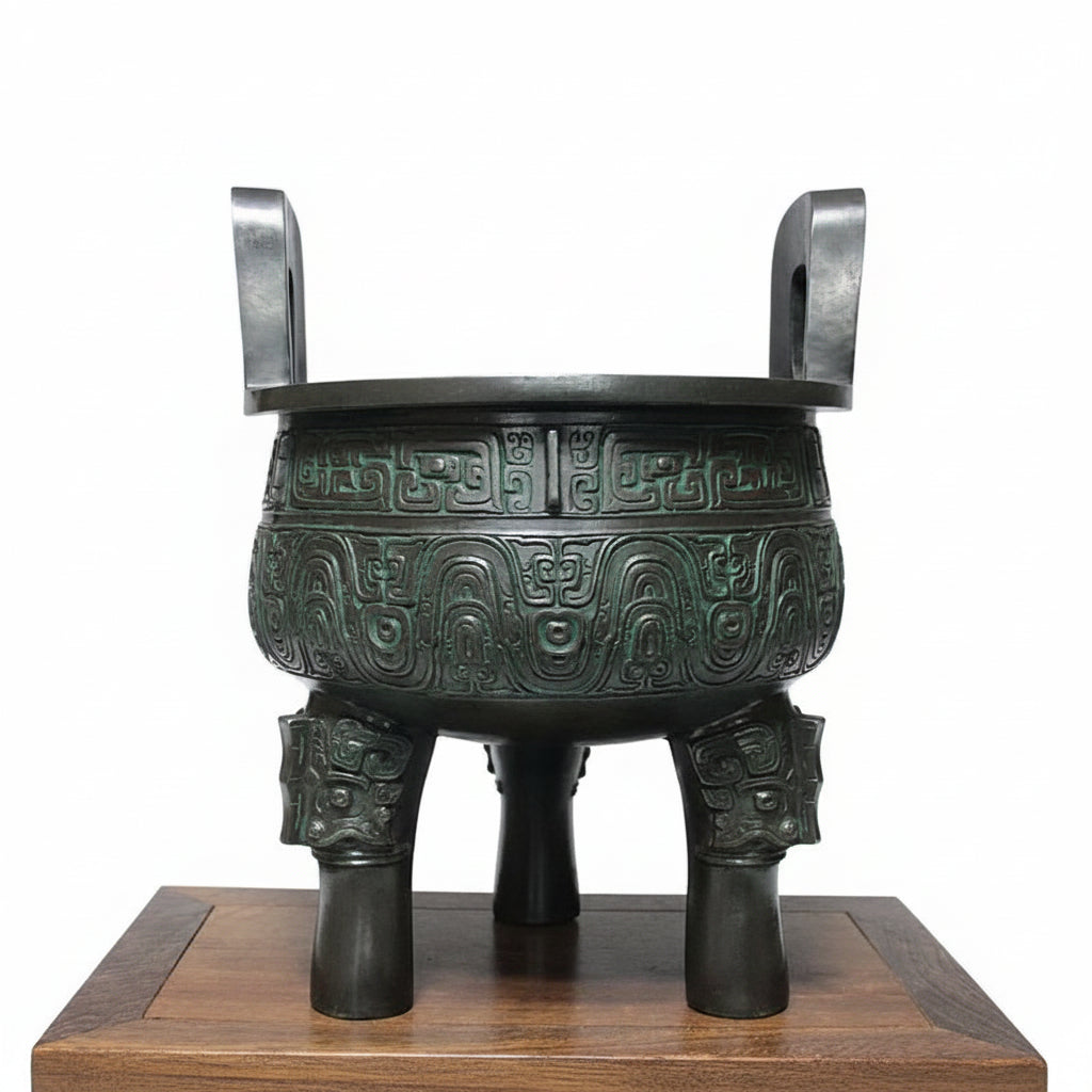 Bronze tripod pot on a wooden platform with Chinese text on a gray background