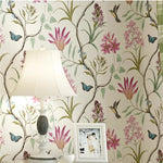 Floral wallpaper with pink flowers, green leaves, and blue butterflies on a white background.