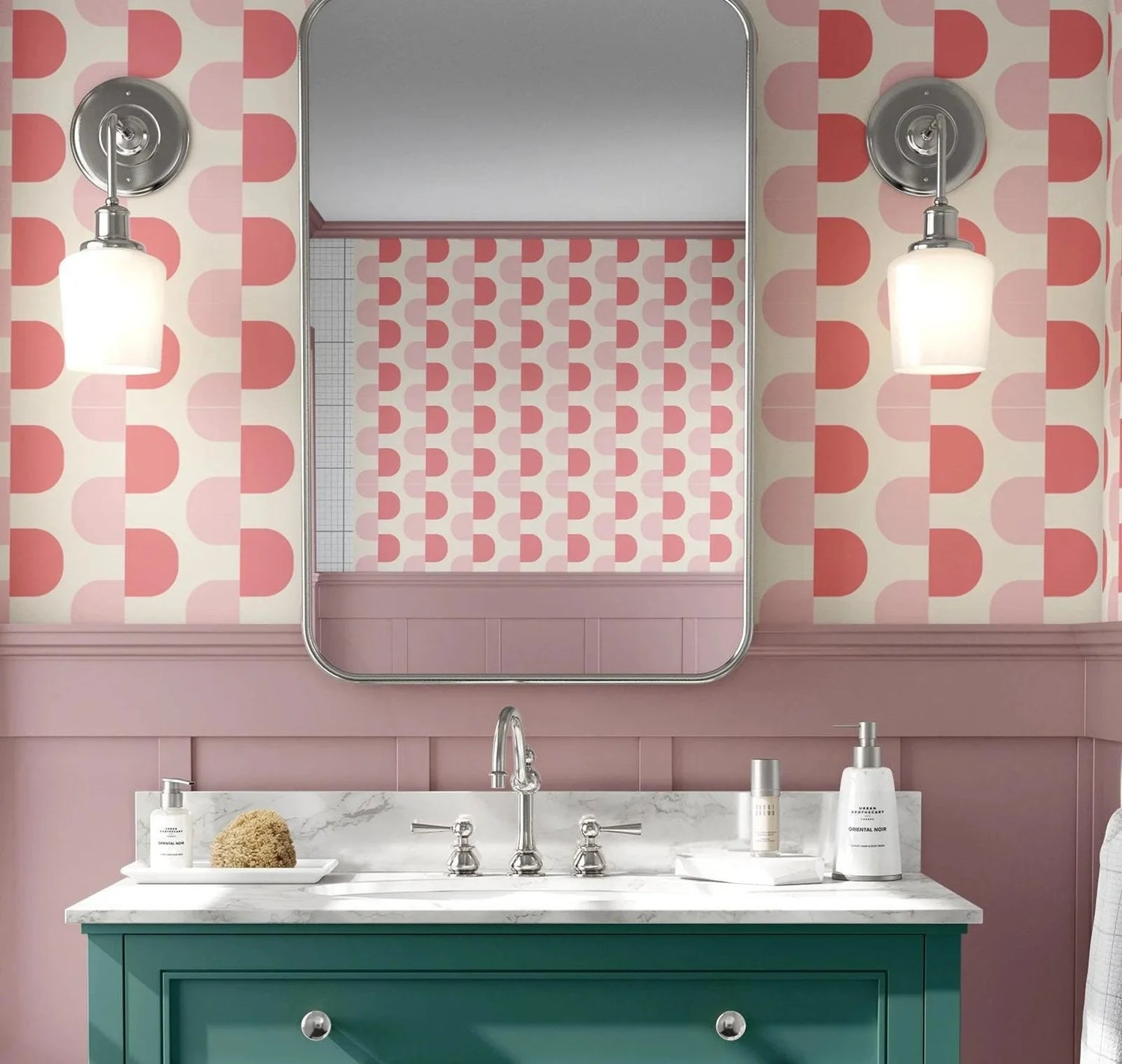 Bathroom with pink geometric wallpaper, green vanity, and white sink.