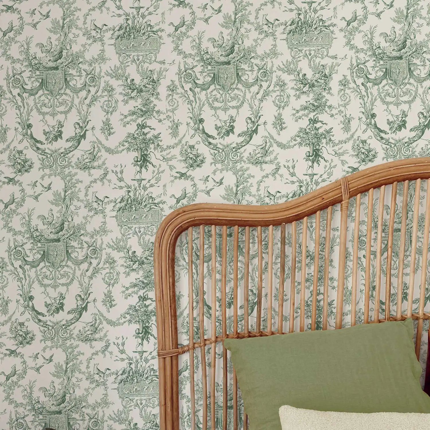 Decorative wallpaper with intricate green patterns on a light background, featuring a wicker headboard and green pillow.