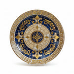 Decorative mosaic plate with blue and gold patterns on a dark background