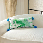 Artisan Chinoiserie garden print throw pillow with blue tassels on a cozy sofa.
