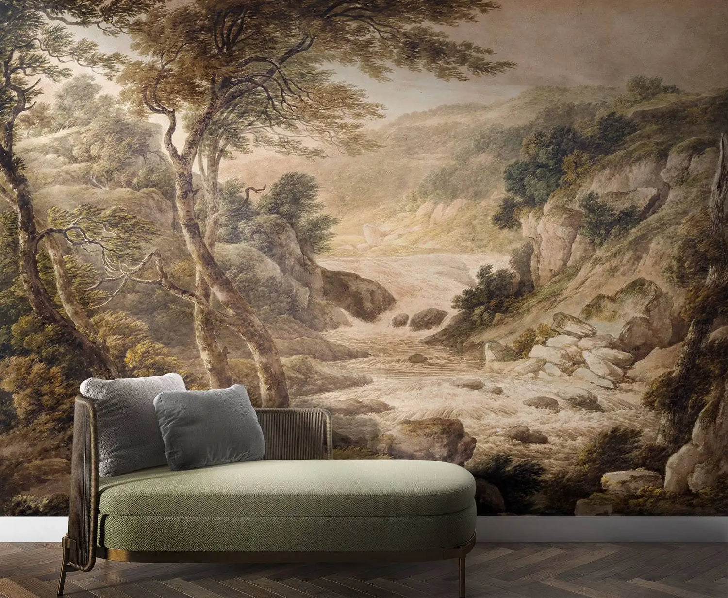 Green sofa in front of a wall mural depicting a landscape with trees and rocks.