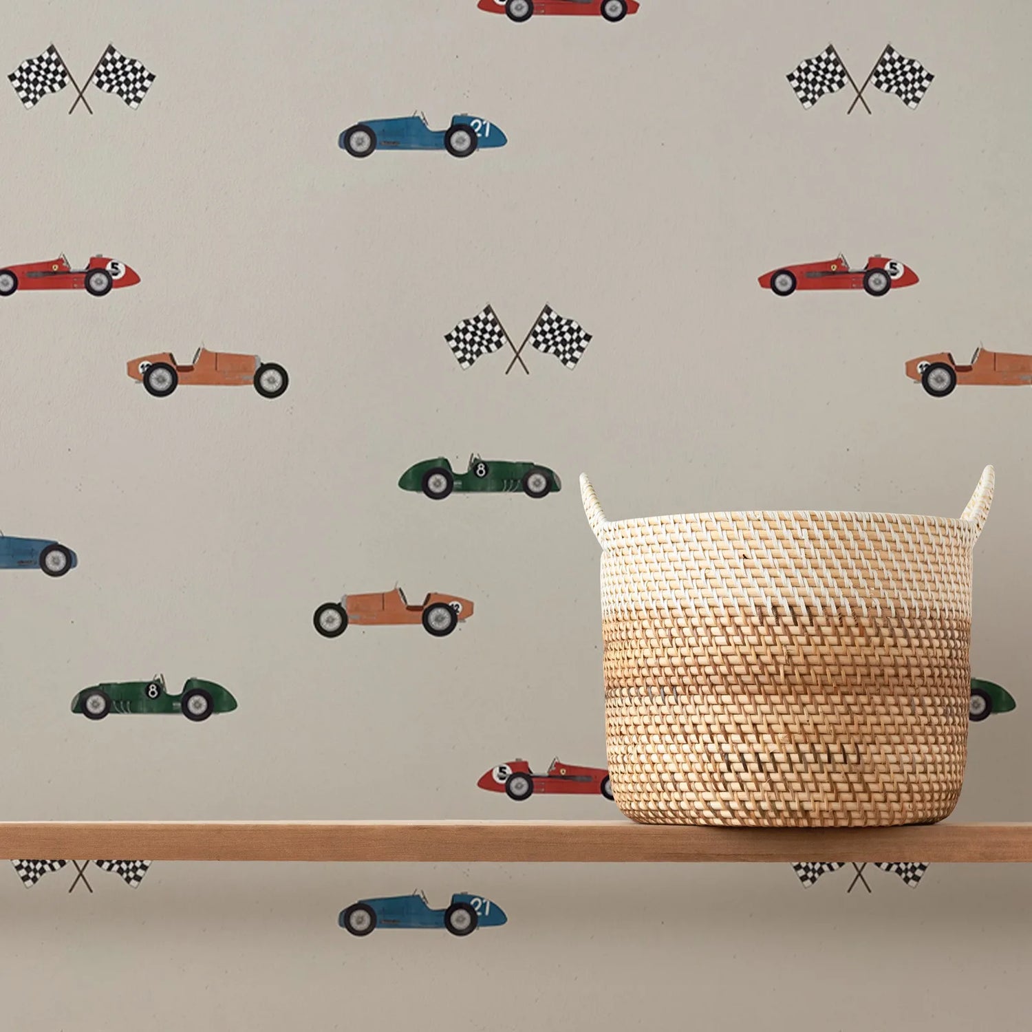 Woven basket on a shelf with race car and checkered flag pattern on the wall behind.