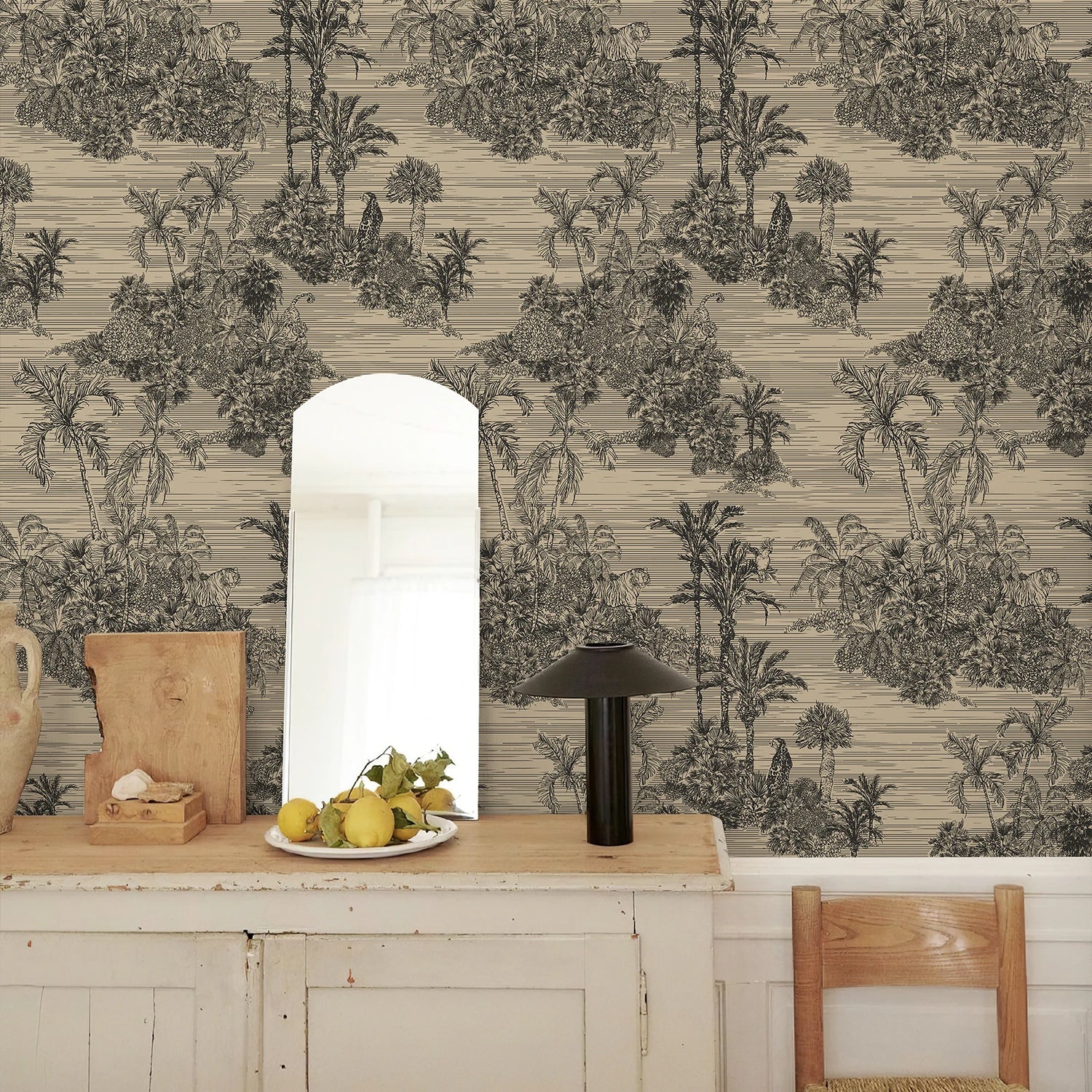 Room interior with a patterned wall, wooden table, and chair.