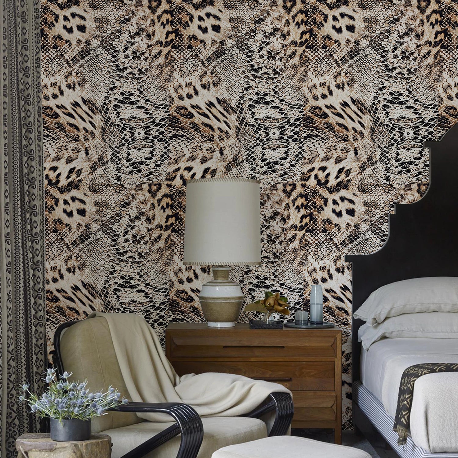 Room interior with leopard print wallpaper, a chair, nightstand, and bed.