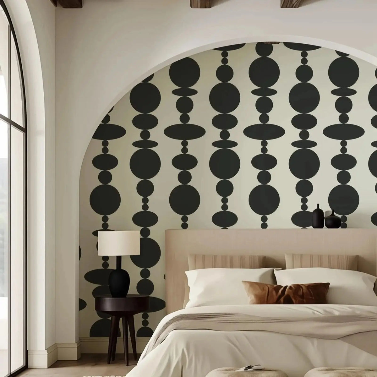 Modern bedroom with black and white patterned wallpaper, bed, and lamp.