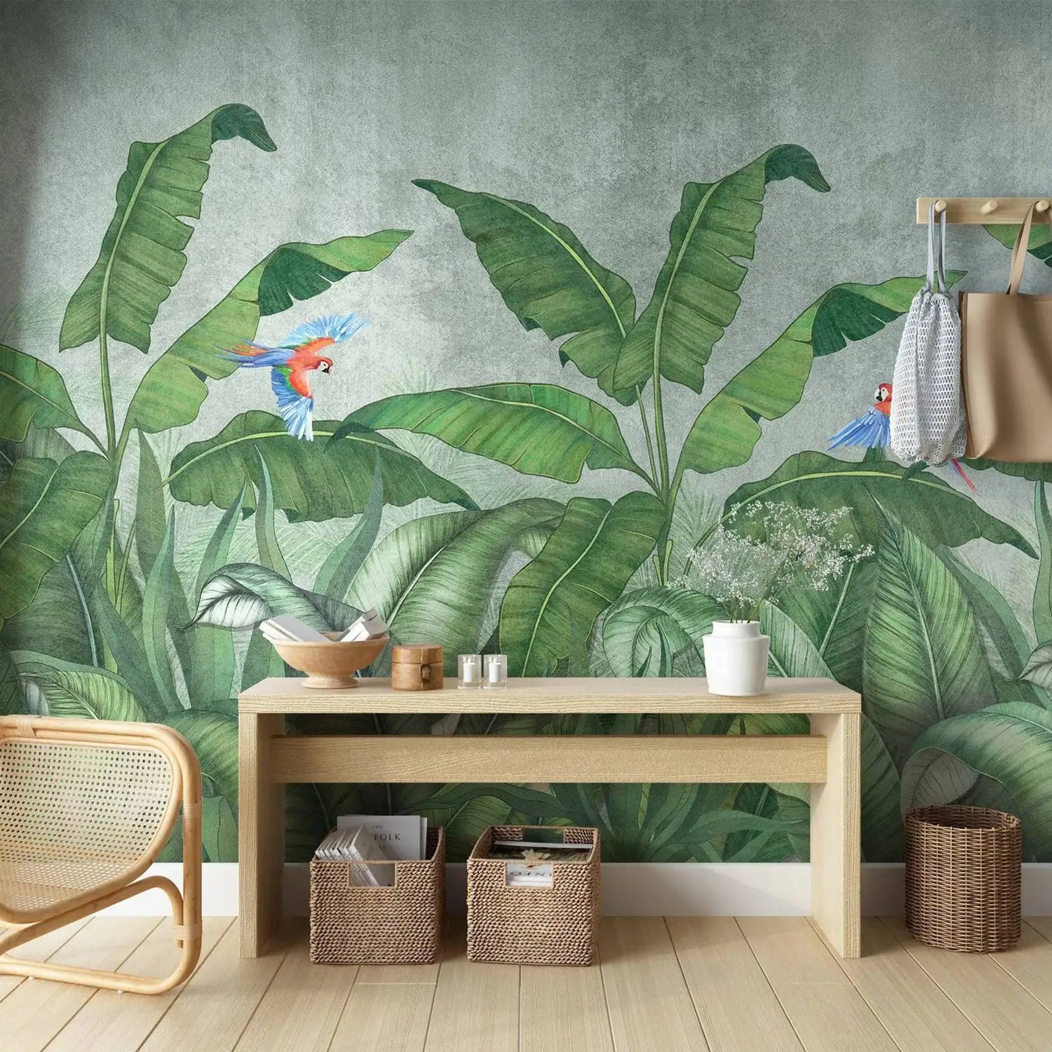 Room interior with a wooden bench, wicker chair, and decorative items against a tropical leaf wallpaper.