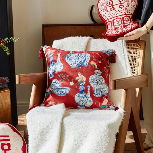 Add a touch of elegance to your decor with this red Chinoiserie-inspired pillow cover. Featuring intricate patterns and adorned with stylish tassels, this cover brings a timeless charm to any sofa or bed, instantly elevating the ambiance of your living space