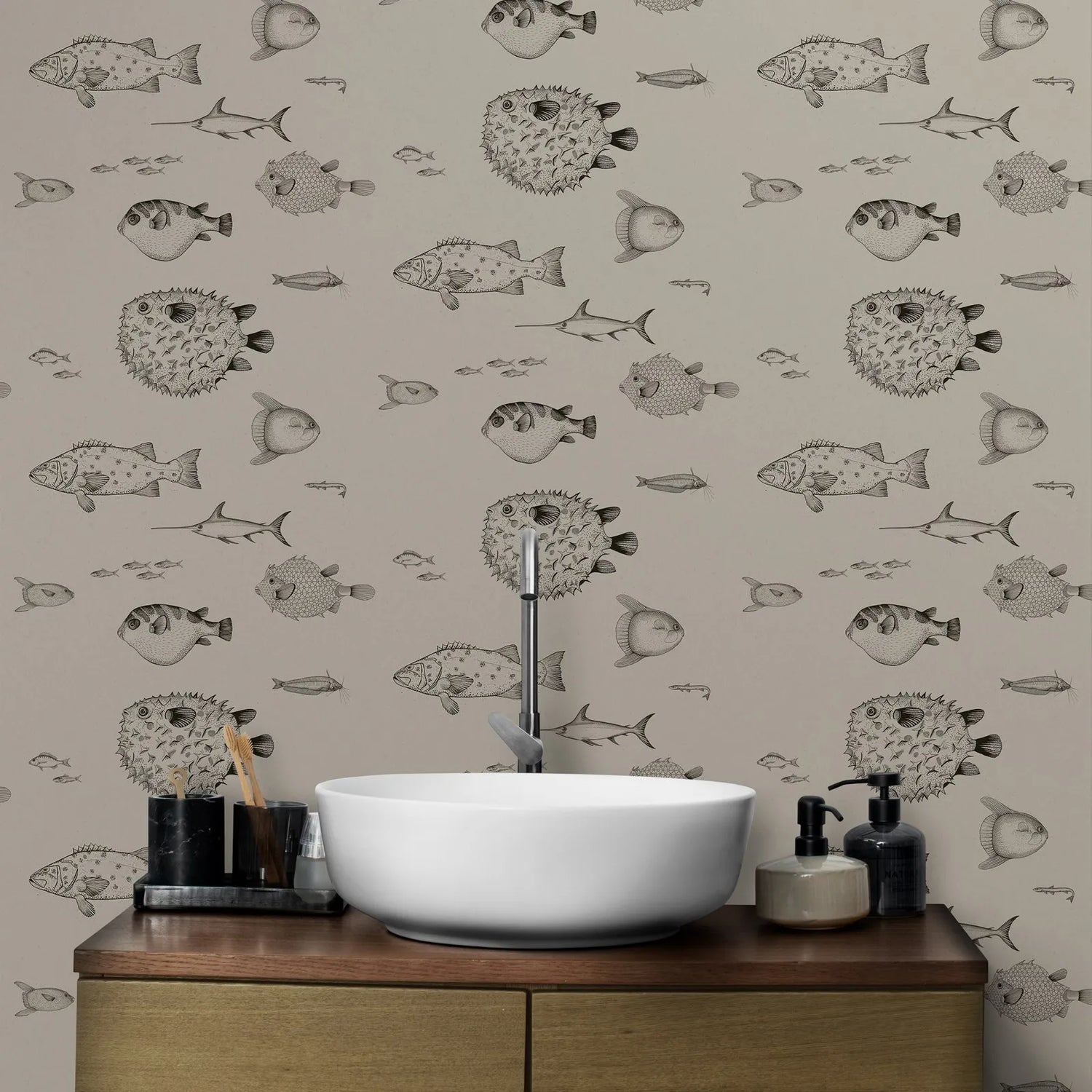 Bathroom with a wooden vanity, white sink, and fish-patterned wallpaper.