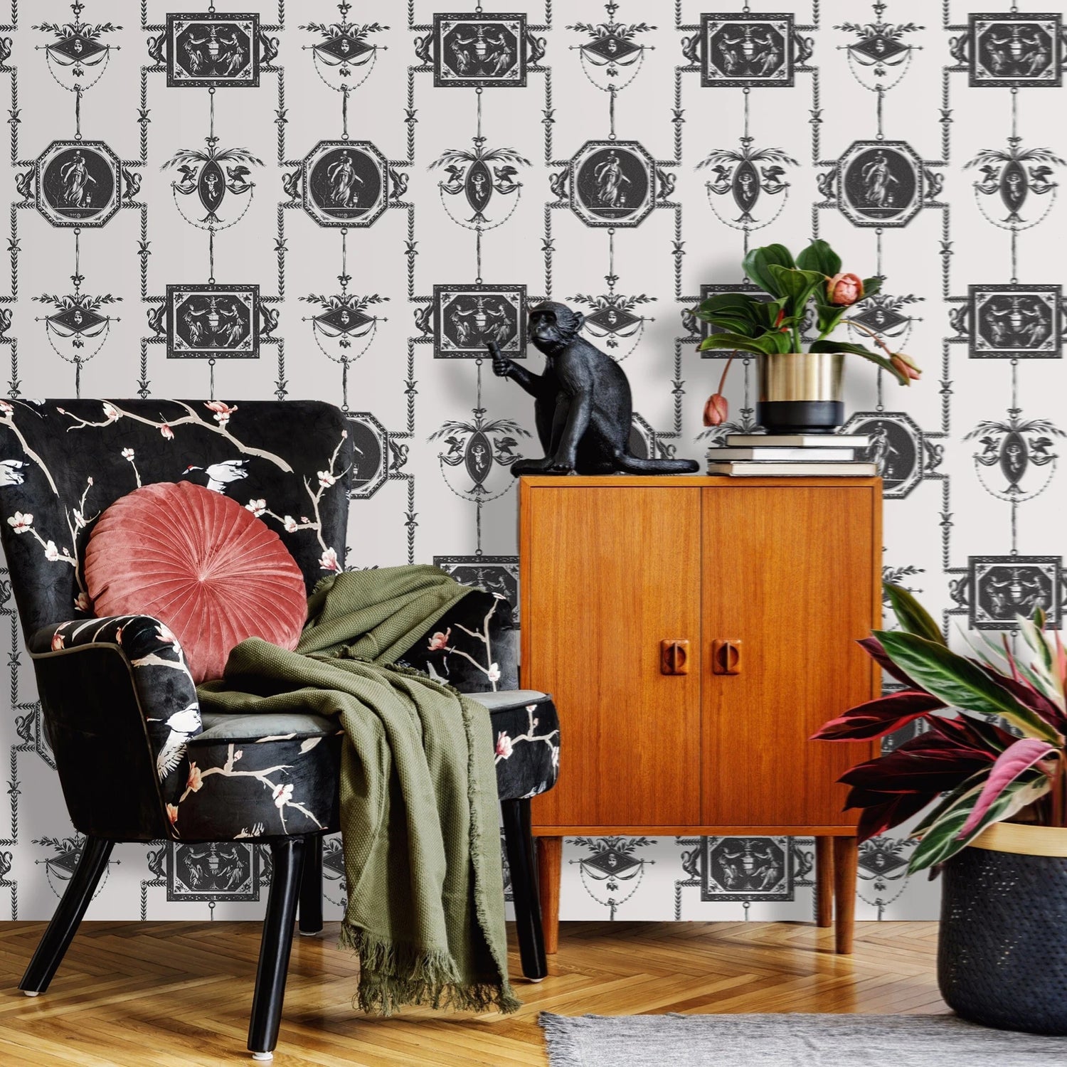 Living room with black and white patterned wallpaper, wooden cabinet, and decorative chair.