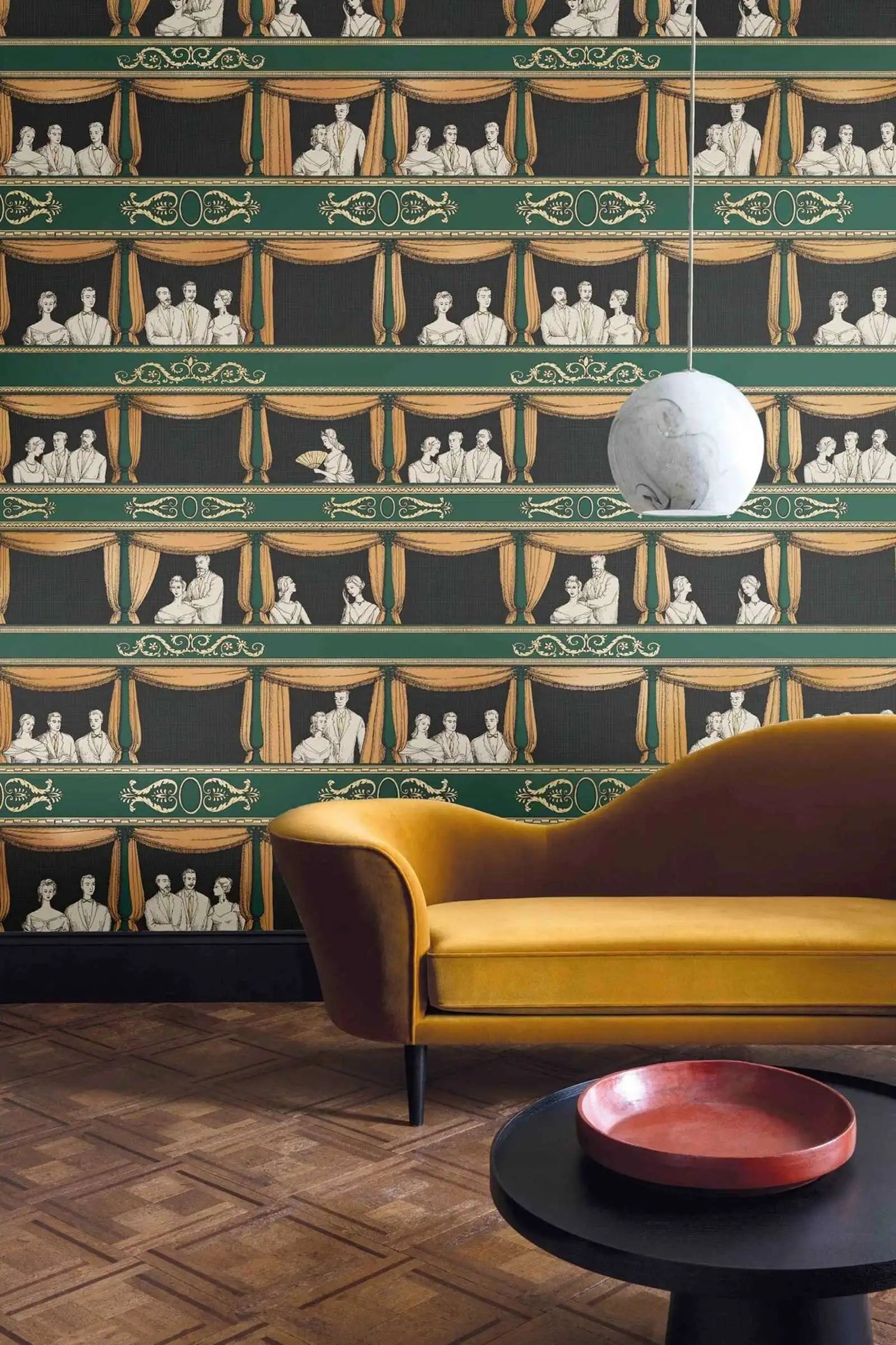 Living room with a yellow sofa against a decorative wall featuring a pattern of people in boxes.