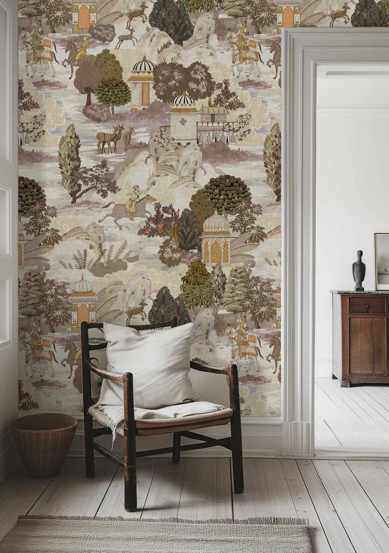 Room with decorative wallpaper featuring nature scenes, a chair with a white cushion, and a wooden cabinet.