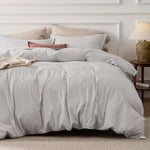 Washed Cotton Duvet Cover Set in Stone offers a blend of comfort and style, featuring a soft, relaxed texture achieved through stone-washing techniques. This process enhances the fabric's softness and imparts a lived-in look, making it a cozy addition to any bedroom.