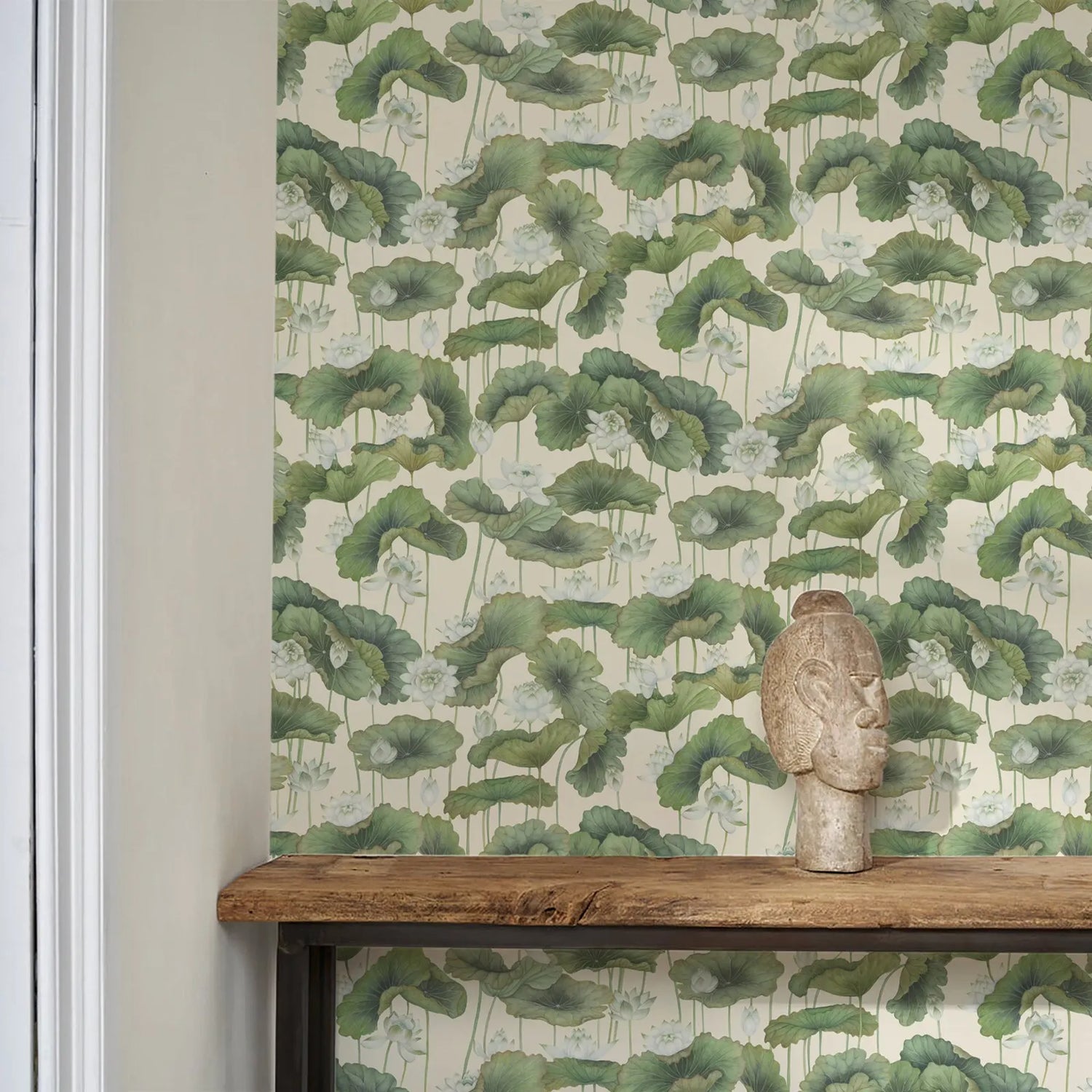 Wallpaper with green leaf pattern on a wall with a wooden shelf below.