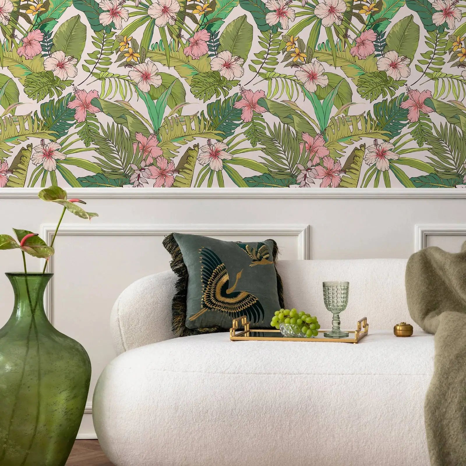 Living room with tropical wallpaper, white sofa, and decorative items.