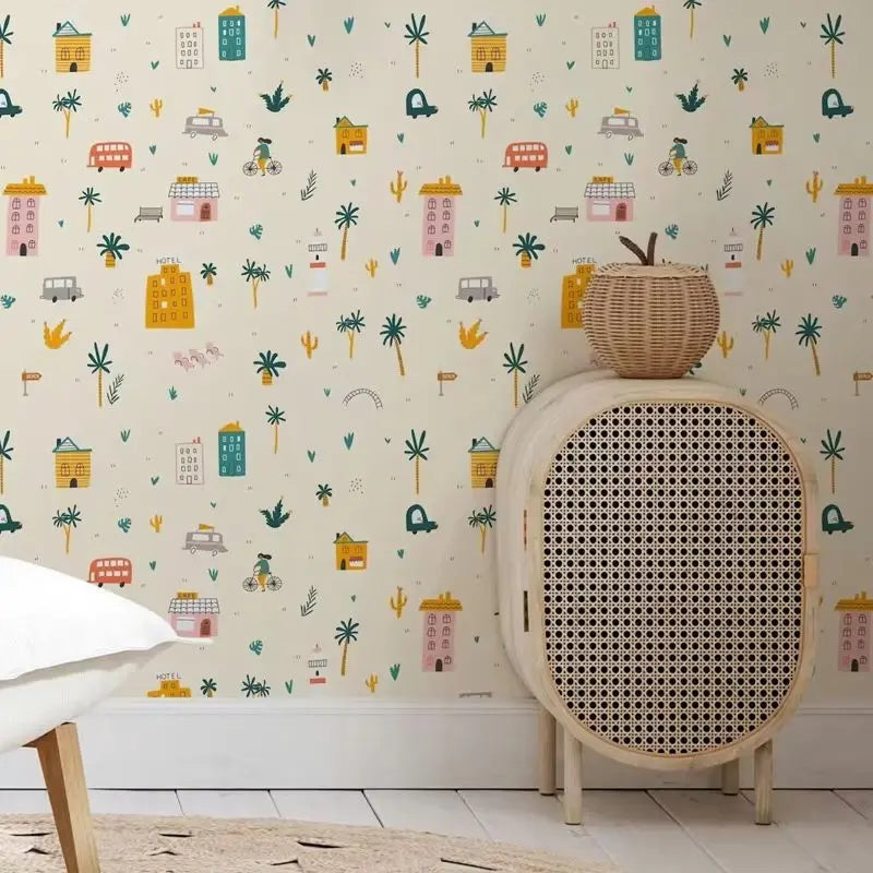 Wicker chair with patterned wallpaper featuring colorful illustrations of buildings and nature.