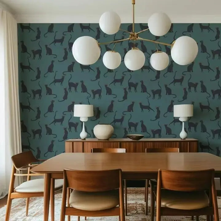 Dining room with wooden table and chairs, white lamps, and a wall with cat pattern.